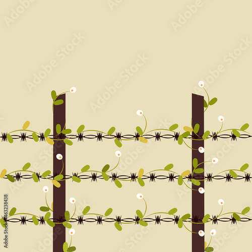Blooming flowers on a barb-wire fence