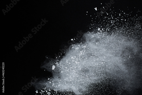 White powder explosion on black background. Colored cloud. Colorful dust explode. Paint Holi.