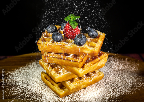 Waffles with berries and sugar