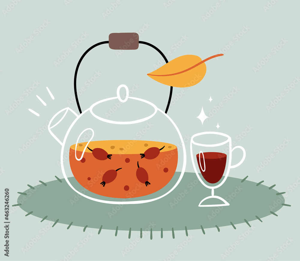 Rosehip tea in a transparent teapot. A glass of mulled wine. Warm autumn drink. Rosehip tea in a transparent teapot. A glass of mulled wine. Warm autumn drink.