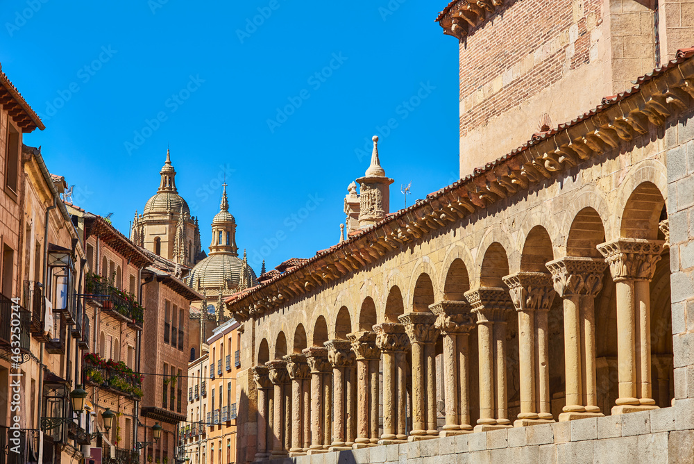 Atria of the Romanesque church of San Martin, with the Juan Bravo street and the Cathedral of Segovia in the background. View from San Martin square. Segovia, Spain.
