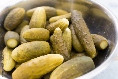 Appetizing pickles in a metal container. Pickled cucumbers.