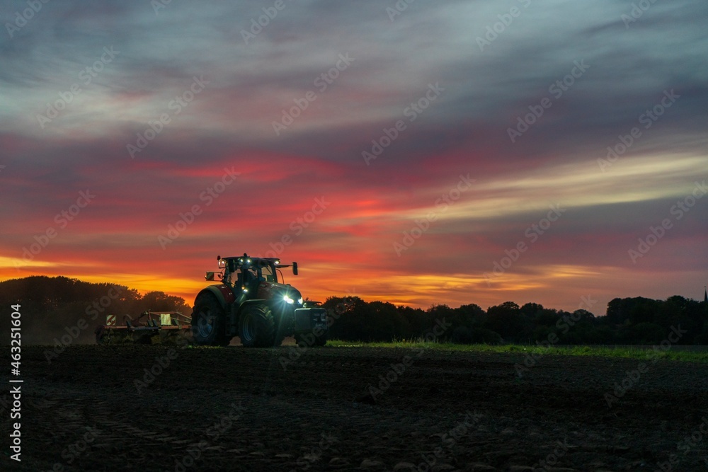 Fototapeta premium tractor at sunset