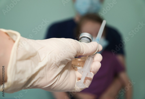 the doctor offers to put the vaccine to the child and the father