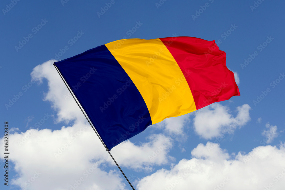 Chad flag isolated on the blue sky background. close up waving flag of Chad. flag symbols of Chad. Concept of Chad. Chad flag isolated on the blue sky background. close up waving flag of Chad. flag symbols of Chad. Concept of Chad.
