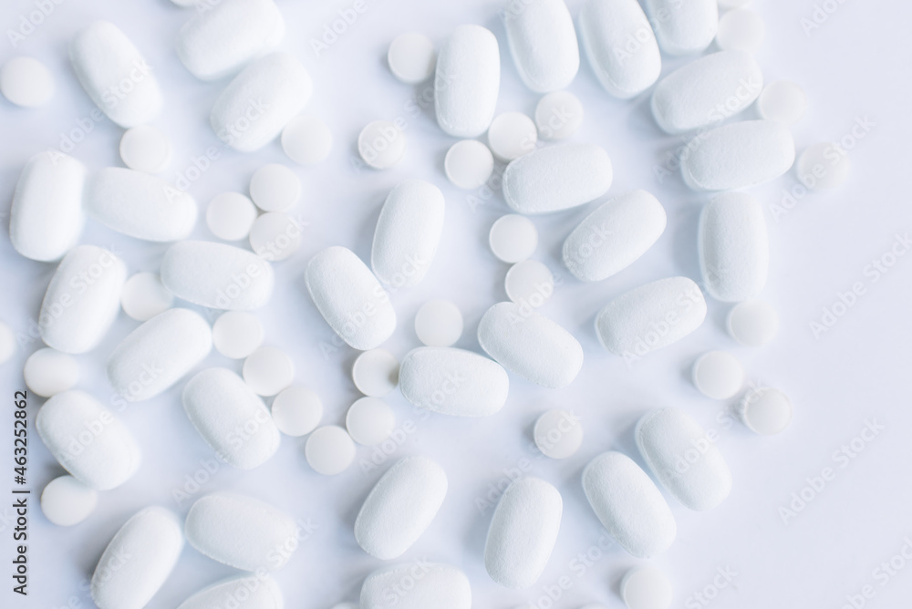 Many white pills on a white background. Health. Many white pills on a white background. Health.