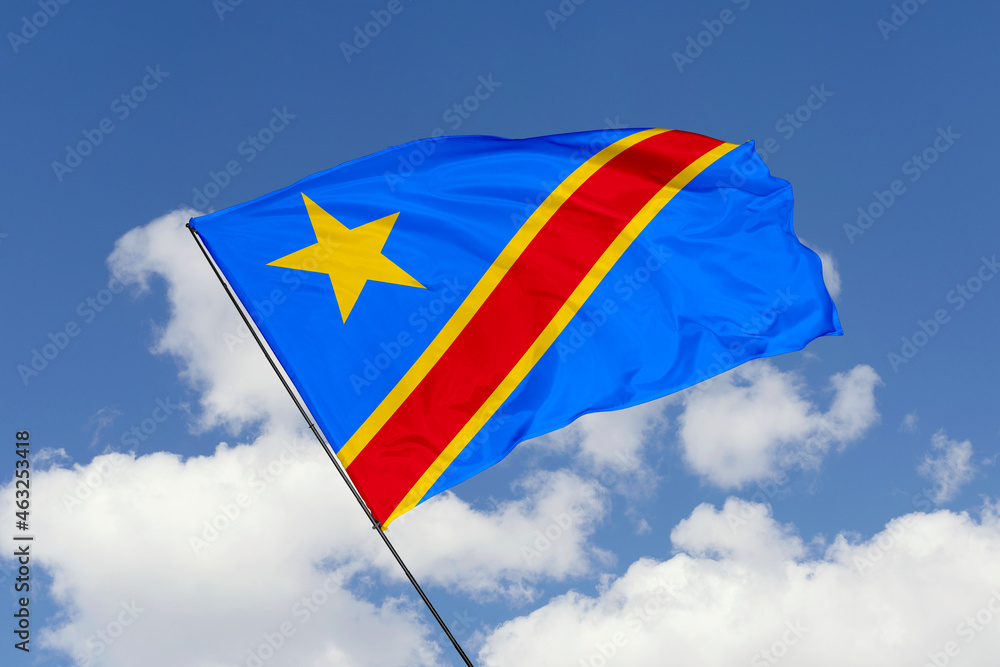 Congo flag isolated on the blue sky background. close up waving flag of Congo. flag symbols of Congo. Concept of Congo. Congo flag isolated on the blue sky background. close up waving flag of Congo. flag symbols of Congo. Concept of Congo.