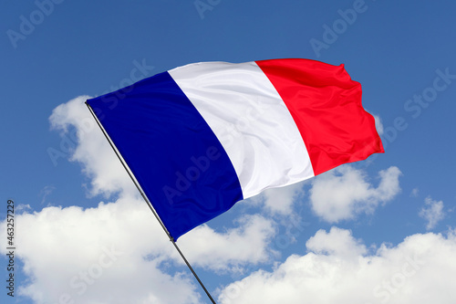 France flag isolated on the blue sky background. close up waving flag of France. flag symbols of France. Concept of France.