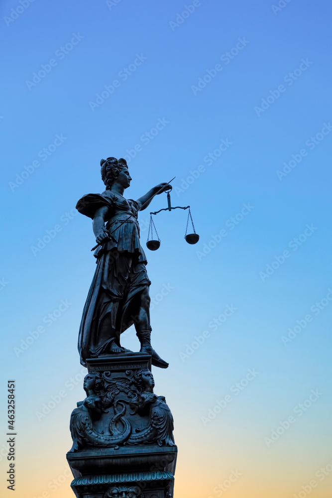 silhouette of Lady Justice at the fountain at Romerberg in Frankfurt silhouette of Lady Justice at the fountain at Romerberg in Frankfurt