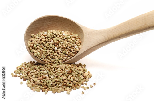 Peeled buckwheat seeds in wooden spoon isolated on white 