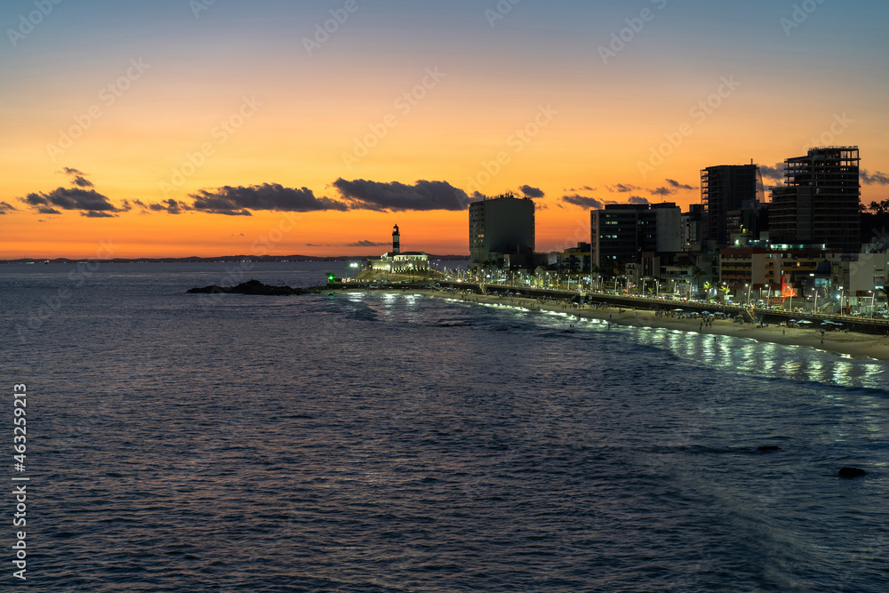 Fototapeta premium Sunset over Barra beach and Barra lighthouse (Portuguese: Farol da Barra), the oldest lighthouse in South America, in Salvador, Bahia, Brazil.
