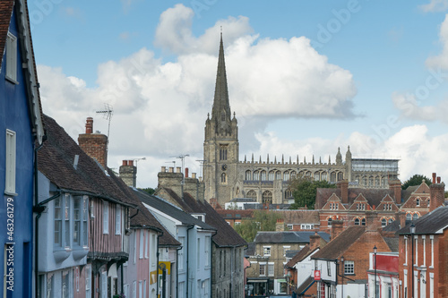 Facade of old colorful terraced cottage houses with Cathedral tower visible in Saffron Walden, England © Haris Photography