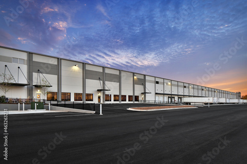 Modern warehouse distribution center at sunset