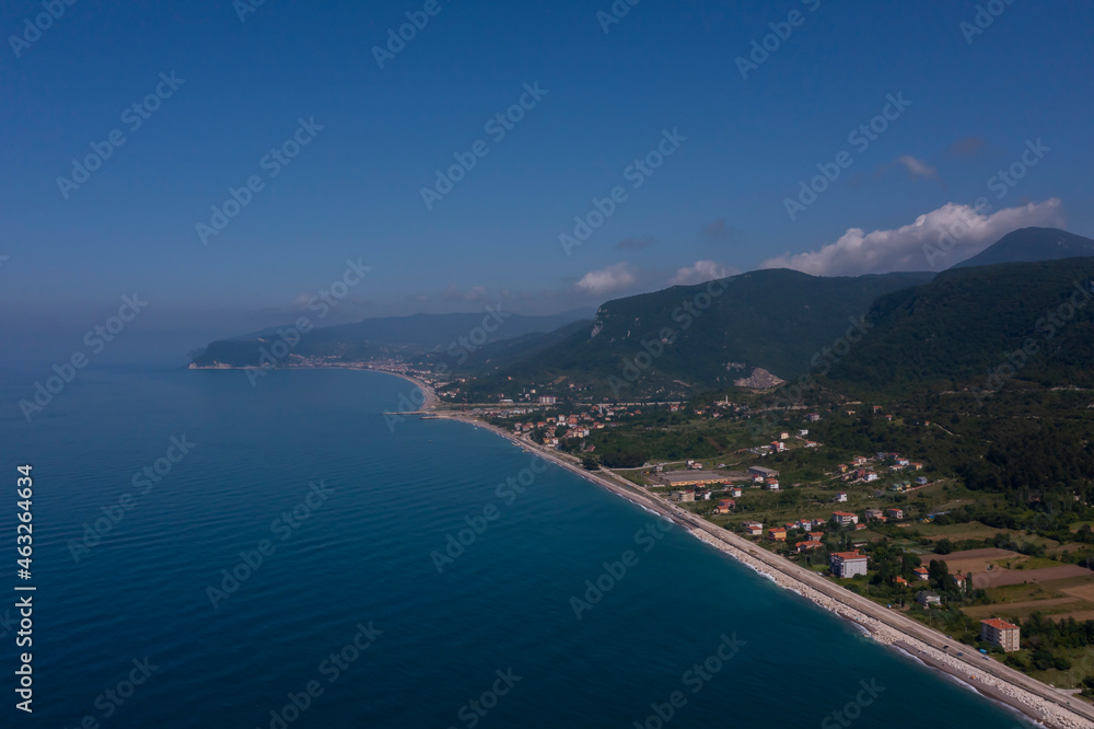 seaside town aerial shot meeting of blue and green black sea, cide, kastamonu, turkey