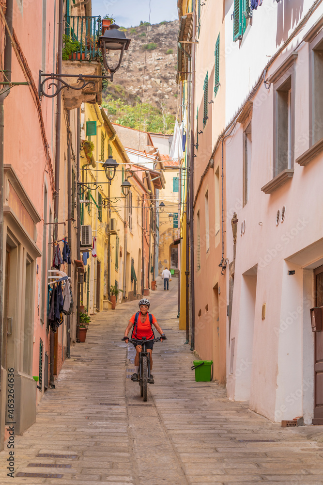 nice active woman exploring  the beautifull village of Rio Nell` Elba on the Island of Elba, Tuscan Arichipelago, Tuscany, Italy