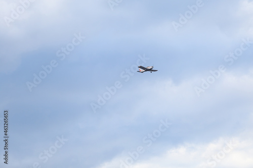 Small private flying airplane yet flying in the sky with cloudy weather.