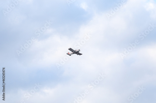 Small private flying airplane yet flying in the sky with cloudy weather.