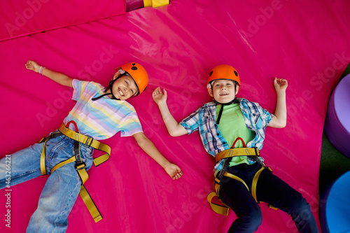 Children in helmets lying on mats, young climbers