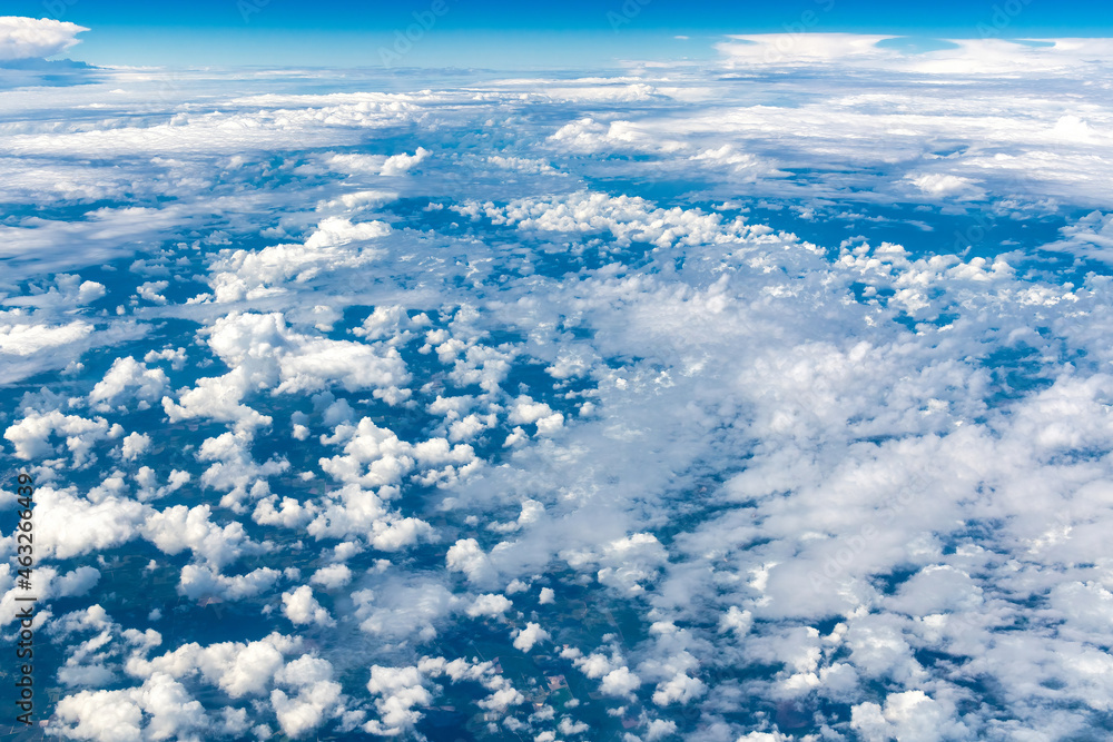 Blue and white cloudscape seen from an aircraft in mid-air Blue and white cloudscape seen from an aircraft in mid-air