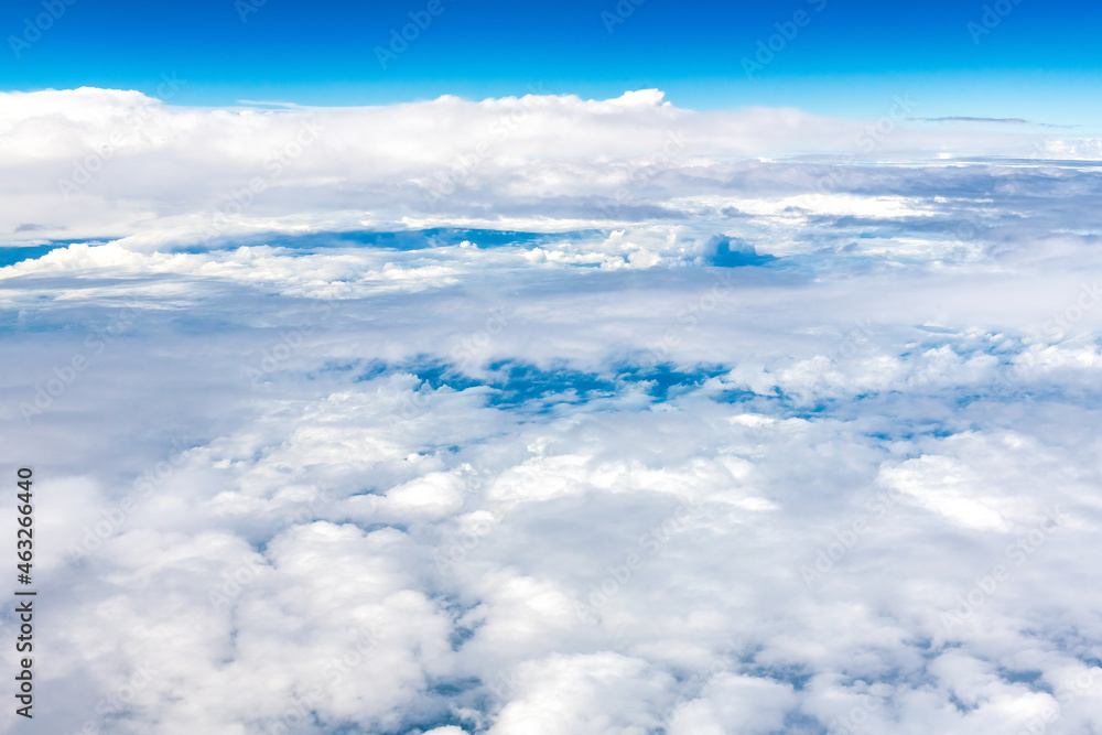 Blue and white cloudscape seen from an aircraft in mid-air Blue and white cloudscape seen from an aircraft in mid-air