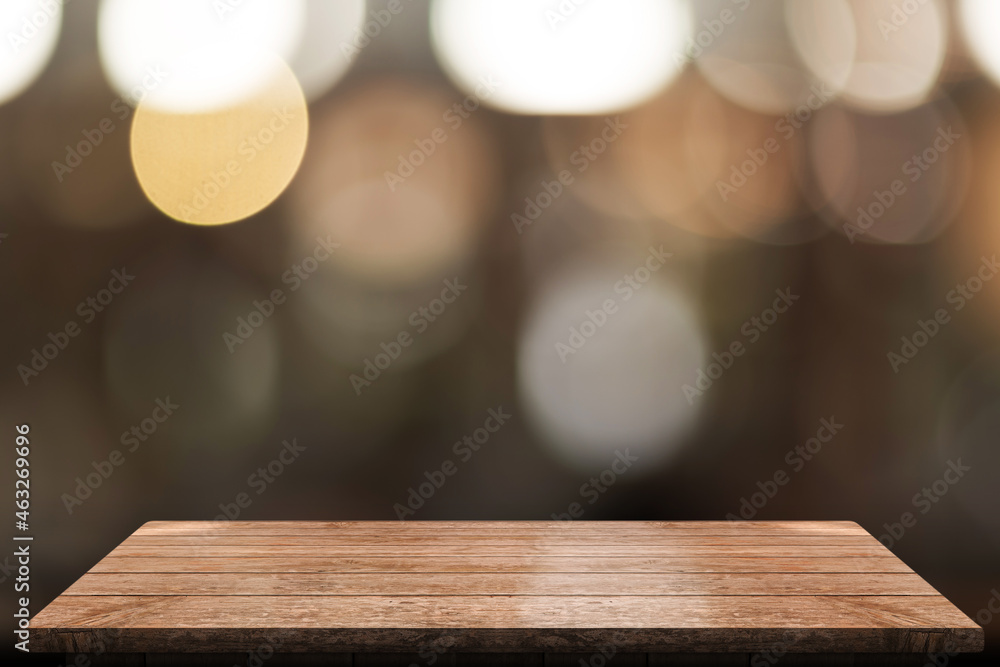 Empty wooden table top with lights bokeh on blur restaurant background. Empty wooden table top with lights bokeh on blur restaurant background.