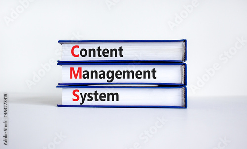 CMS content management system symbol. Concept words CMS content management system on books on a beautiful white table, white background. Business, CMS content management system concept. Copy space.