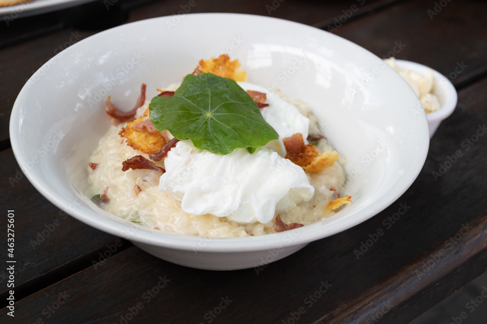plate of delicious risotto with poached egg and cheese chips plate of delicious risotto with poached egg and cheese chips