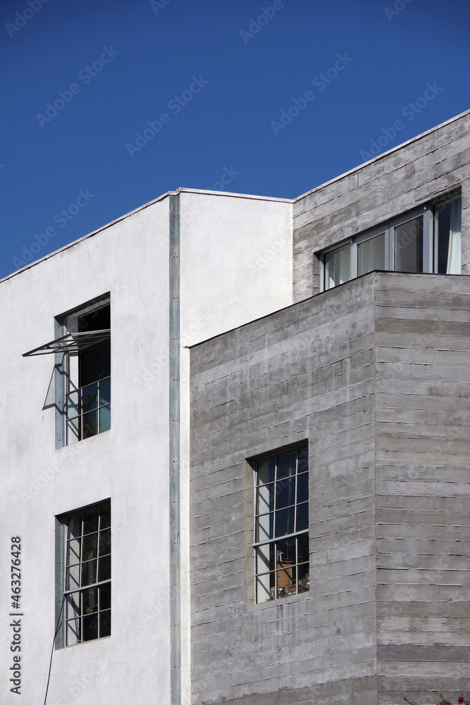 Low angle view of a section of a simple minimalist office building under blue sky