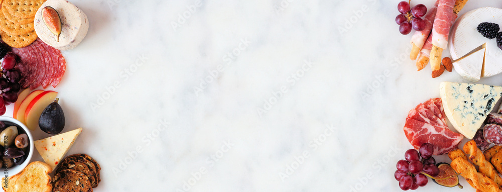 Mixture of cheese and meat appetizers. Overhead view double border on a white marble banner background with copy space. - obrazy, fototapety, plakaty 