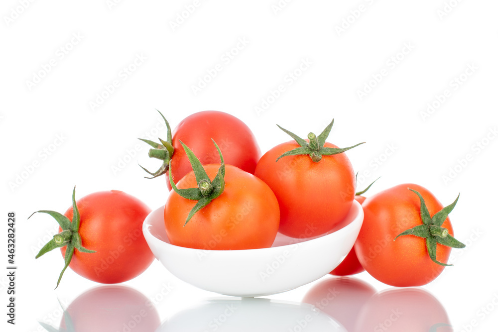 Several red organic tomatoes with a white ceramic saucer, close-up, isolated on white. Several red organic tomatoes with a white ceramic saucer, close-up, isolated on white.