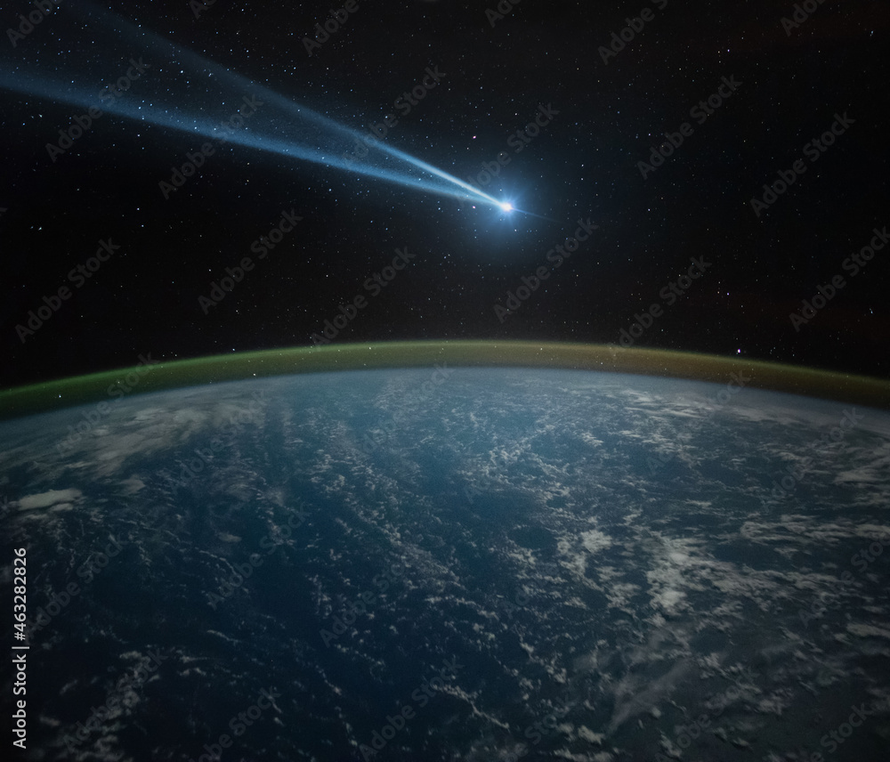 Fototapeta premium Comet, asteroid, meteorite flying to the planet Earth. Glowing asteroid and tail of a falling comet threatening the safety of the Earth. Elements of this image furnished by NASA.