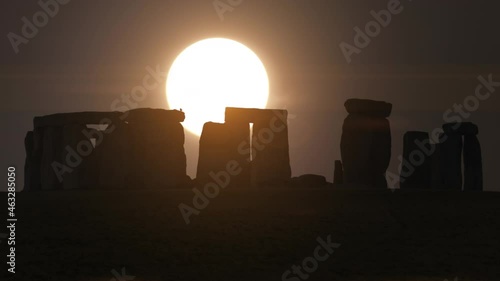 Stonehenge, England, UK at Sunrise Sunset, Ancient Stone Monument - Rare moment of Sun directly behind Stonehenge.