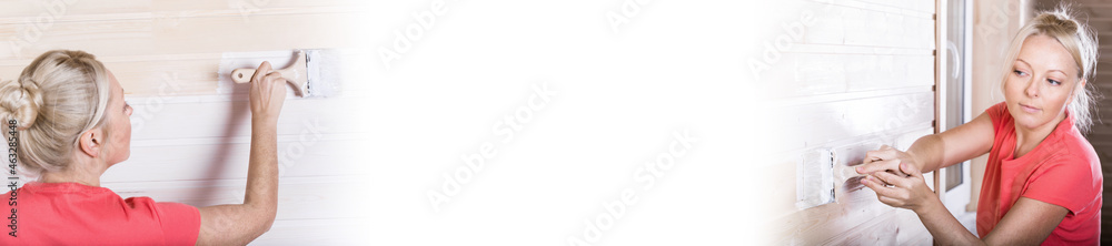 Woman painting wooden boards in white color with brush. Long banner Woman painting wooden boards in white color with brush. Long banner