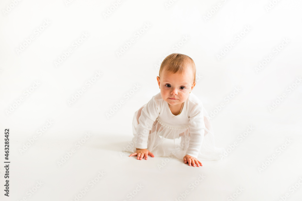 Cute baby on a white background in a white bodysuit. Cute baby on a white background in a white bodysuit.