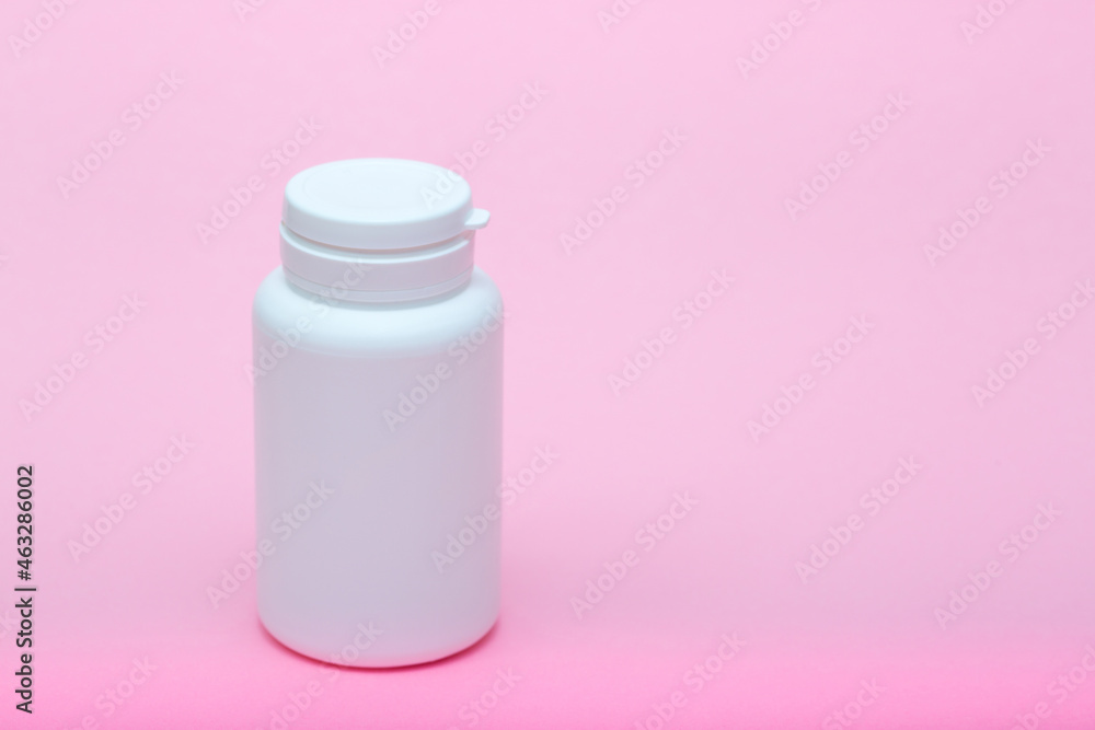 White different medecine or cosmetic jars on a pink background as a concept of cosmetology of medecine and treatment White different medecine or cosmetic jars on a pink background as a concept of cosmetology of medecine and treatment