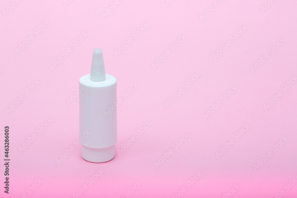 White different medecine or cosmetic jars on a pink background as a concept of cosmetology of medecine and treatment White different medecine or cosmetic jars on a pink background as a concept of cosmetology of medecine and treatment