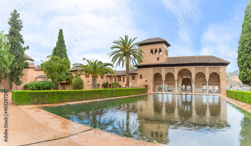 View at the Partal Palace or Palacio del Partal , a palatial structure around gardens and water lake inside the Alhambra fortress complex located in Granada, Spain photo