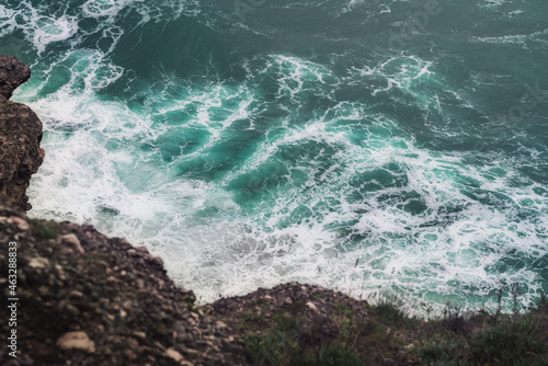 Aerial view of ocean waves and rocks