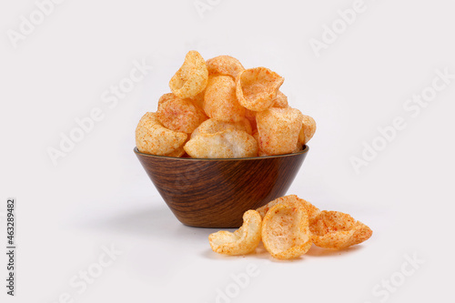 Fried and Spicy Moon Cup, Vatka, Katori, Moon Chips, Snacks or Fryums (Snacks Pellets) served in a bowl or White background. selective focus - Image