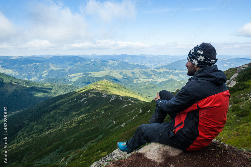 A man admires a view of the mountains, Ukrainian Carpathians A man admires a view of the mountains, Ukrainian Carpathians