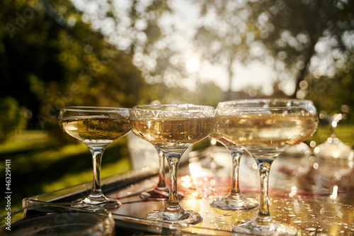 Table set for an event party or wedding reception. Banquet table design. Festive glasses with champagne and white wine.