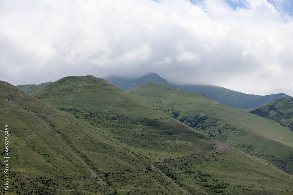 clouds over the beautiful green Caucasus mountains landscape
