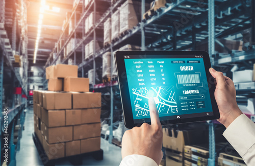 Warehouse management innovative software in computer for real time monitoring of goods package delivery . Computer screen showing smart inventory dashboard for storage and supply chain distribution . photo