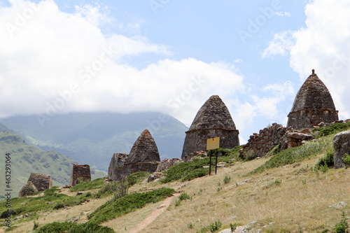 ancient ruined conical old abandoned tombs in "city of dead" necropolis in Eltubu, Chegem Valley, slopes of Caucasus mountains, Russia