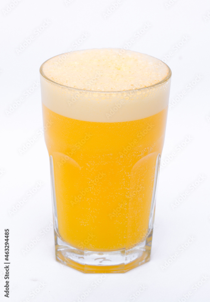 A glass of vitamin orange juice cool on a white background A glass of vitamin orange juice cool on a white background