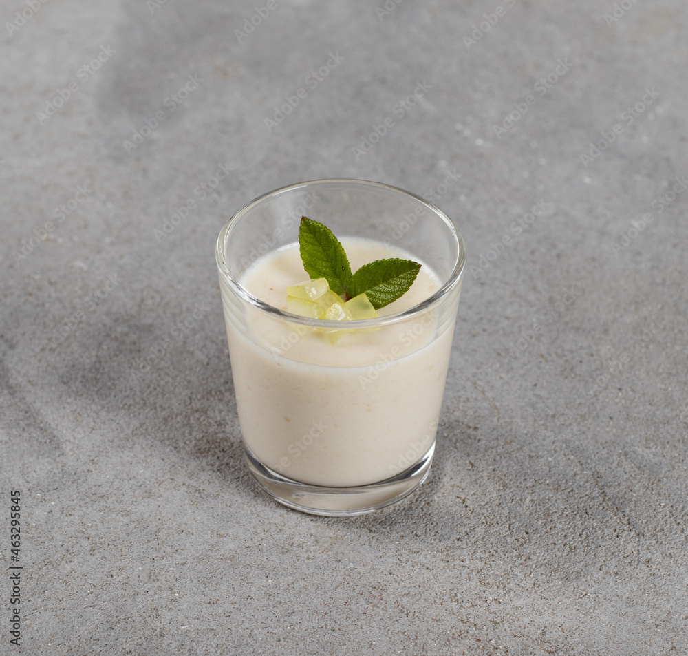 Vegan dessert, White grape jelly in a glass on a light gray background Vegan dessert, White grape jelly in a glass on a light gray background