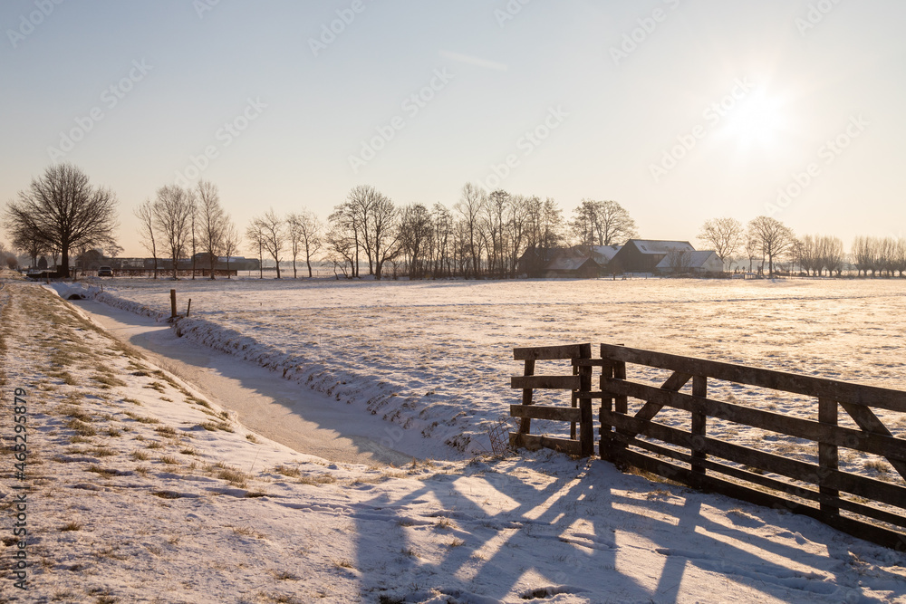 Farms in the countryside with snowy meadows.