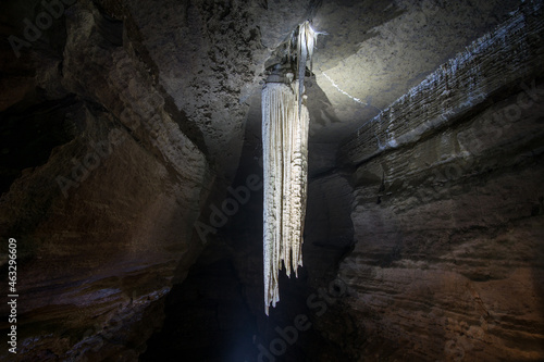 illuminated large stalactite in doolin cave in ireland photo