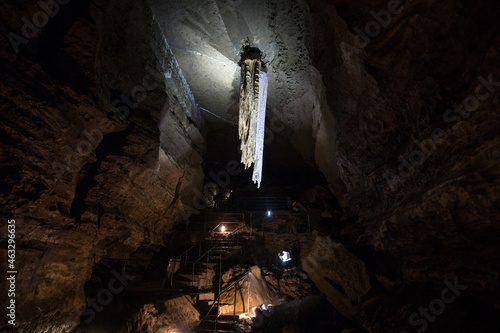illuminated large stalactite in doolin cave in ireland photo