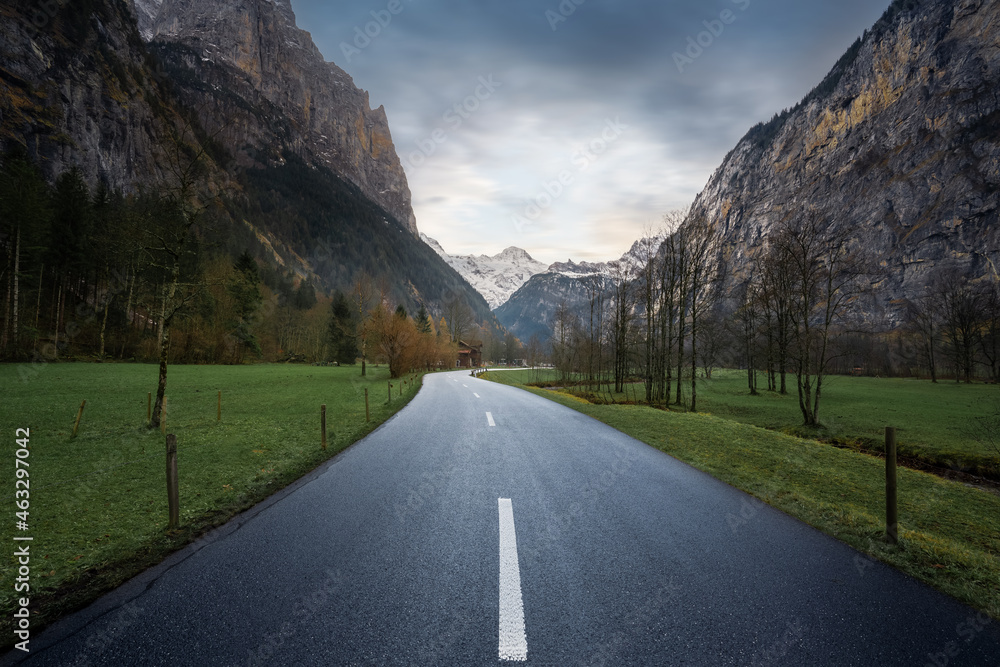 Road view leading straight into Bernese Alps Mountains - Lauterbrunnen, Switzerland. - obrazy, fototapety, plakaty 